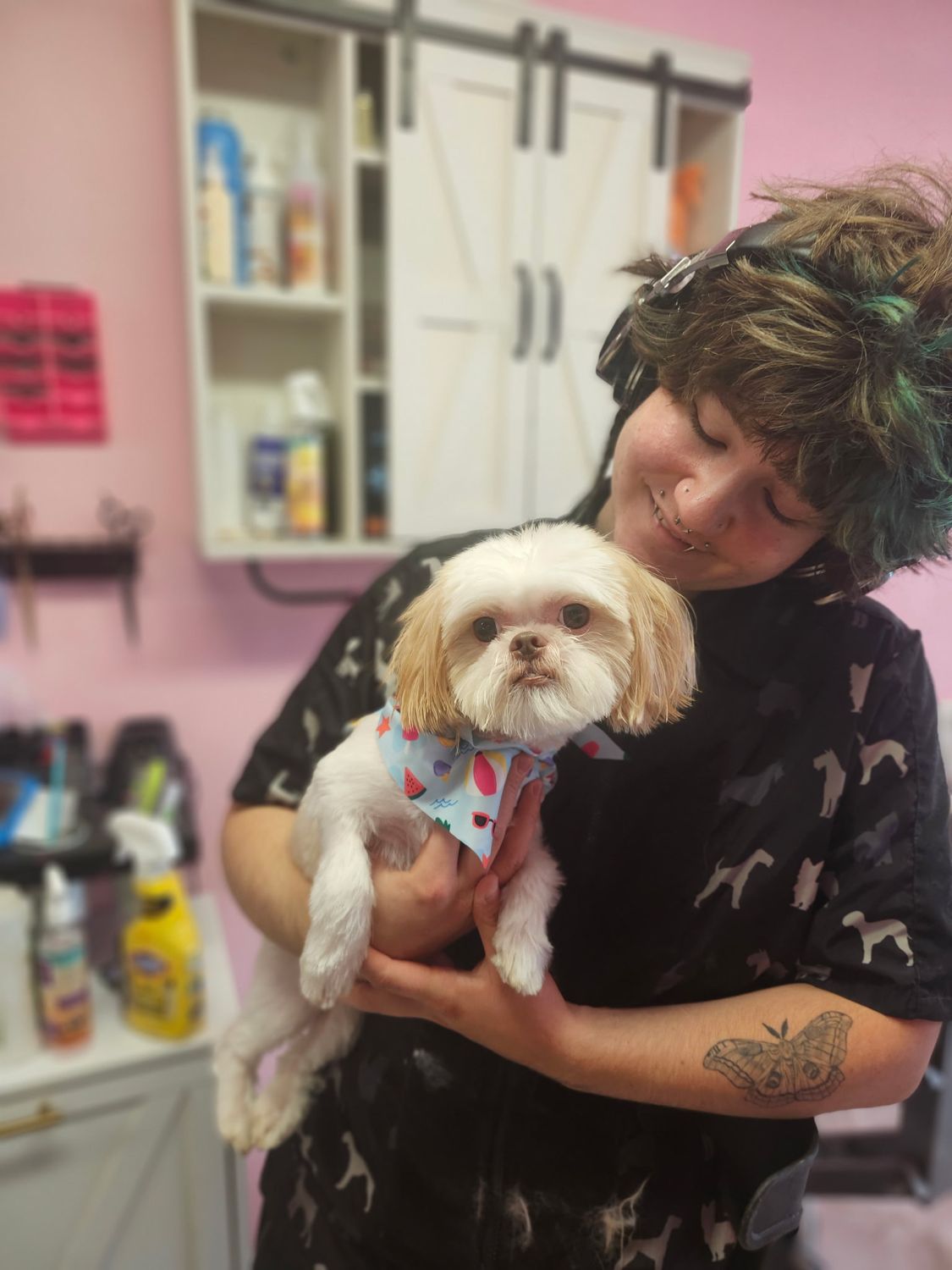 Andrea, owner of Puppycut Salon, holding a freshly groomed pup